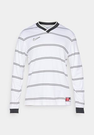 Jersey à manches longues blanc avec des rayures horizontales noires, un col en V avec une bordure noire et un logo Nike sur le haut de la poitrine gauche.