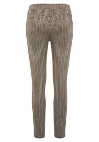 Fitted trousers featuring a houndstooth pattern in brown and black, with a smooth texture and side pockets, showing a narrow leg design.