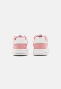 Rosa kanvas sneakers med vita detaljer, som har en slät textur och vadderad krage. Bakifrån syns rundad häl och hållbar sula.