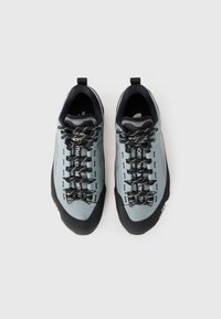 Grey climbing shoes featuring a streamlined design, synthetic upper, black rubber toe cap, and distinctive lacing system with brand logo accents.