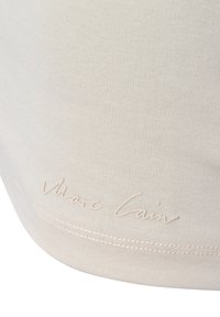 Beige katoenen top met ribbelstructuur, met een subtiel reliëf "Marc Cain" logo nabij de zoom. Glad afwerking en aansluitend ontwerp.