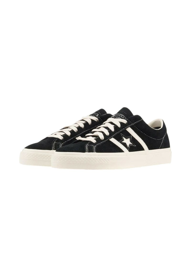 Black low-top sneakers with white laces, white sole, and star logo on the side, shown from a three-quarter front angle.