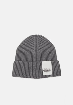 Gray ribbed beanie with a folded cuff and a white label featuring black text. Made of a soft knit material, with a textured surface.