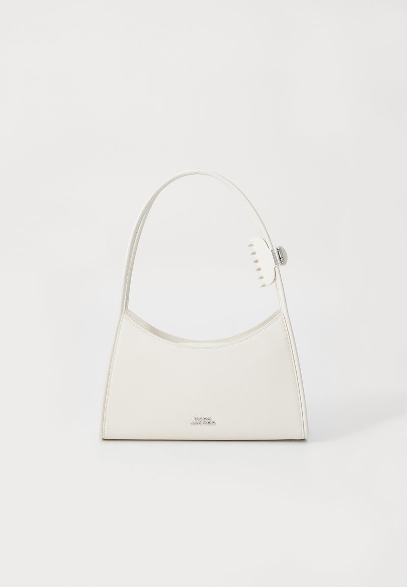 White leather shoulder bag with curved top, small claw clip on strap, and silver "Marc Jacobs" logo on front center.