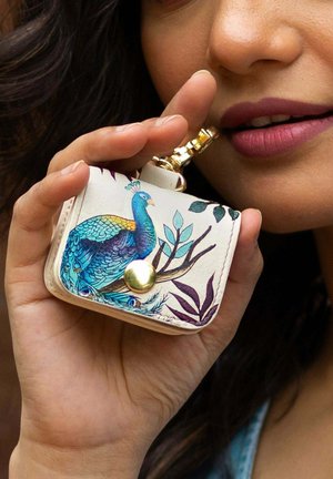 Leather wallet featuring a colorful peacock design, gold hardware, and a textured surface with green and purple accents.