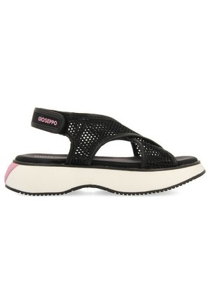 Sandalia de malla negra con correa ajustable, suela de plataforma en blanco y acentos en rosa, con una forma ergonómica y banda texturizada.