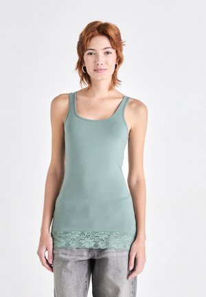 Mint green tank top with a fitted design, featuring a lace trim at the bottom. Fabric is smooth, with thick straps and a scoop neckline.
