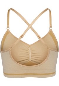 Beige sportbh med ribbad textur, korsade axelband och rynkad detalj fram. Har mjukt tyg och en subtil gul accentrand.