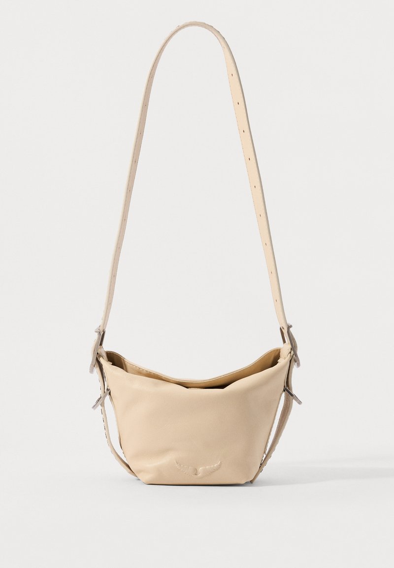 Beige leather handbag with a soft, curved shape. Features an adjustable strap and subtle embossed logo on the front. Smooth texture.