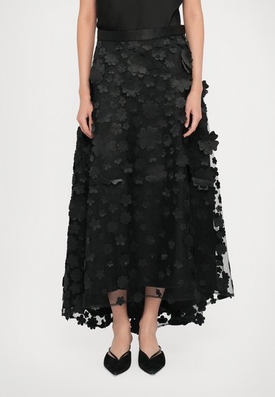 Black floral skirt featuring a layered design with three-dimensional flower appliqués, sheer fabric, and a satin waistband.