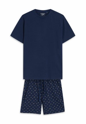 Marineblaues Baumwoll-T-Shirt mit kurzen Ärmeln, kombiniert mit passenden marineblauen Shorts, die ein kleines goldenes Palmbaum-Muster aufweisen. Beide Teile haben eine lockere Passform.