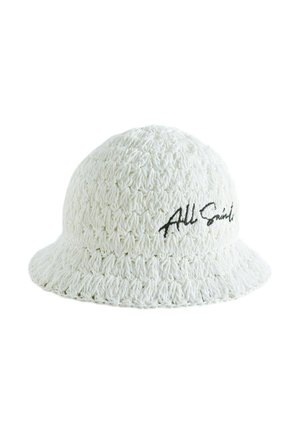 White crochet bucket hat with wide brim and black "AllSaints" embroidery on the side.