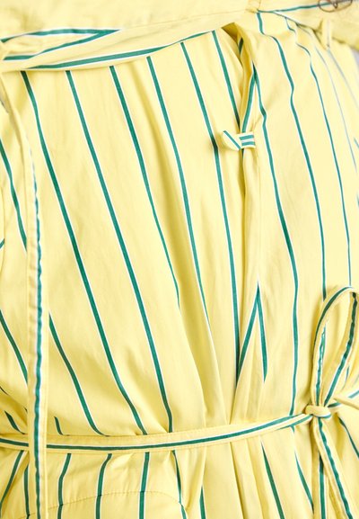 Yellow dress with vertical teal stripes, featuring a fitted waist, tie belt, and smooth, lightweight fabric with a subtle sheen.