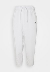 Vita bomullsjoggers med elastisk midja, justerbar dragsko och liten grå Nike-logotyp på vänster sida. Kortad längd.