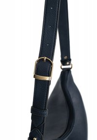 Navy blue leather bag strap with textured finish, featuring a gold-tone metal buckle and multiple adjustment holes for length.