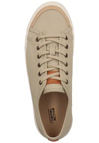Beige canvas sneaker with round toe, lace-up closure, and tan leather accents. Features a padded collar and "camel active" branding inside.