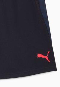 Pantalones cortos deportivos de color azul marino con una tela texturizada, que cuentan con un logotipo de Puma rosa en la parte inferior izquierda y una cinturilla suave.