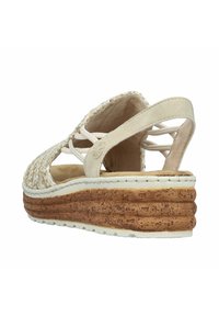 Wedge sandals with a woven upper and a cork-textured platform sole. Light beige color, with adjustable back strap and crisscross design.