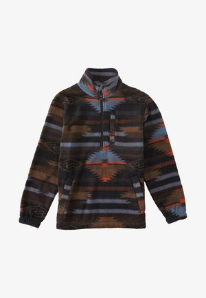 Polarowy sweter z pół zamkiem w kolorze brązowym, niebieskim i czerwonym, z geometrycznymi wzorami. Posiada kieszeń z przodu oraz elastyczne mankiety.