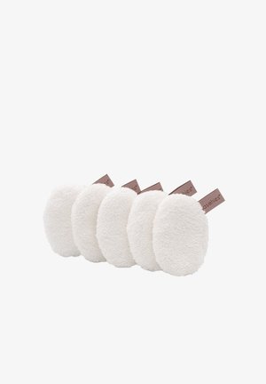Five oval, plush white makeup remover pads with a soft, textured fabric. Each has a small brown label attached.