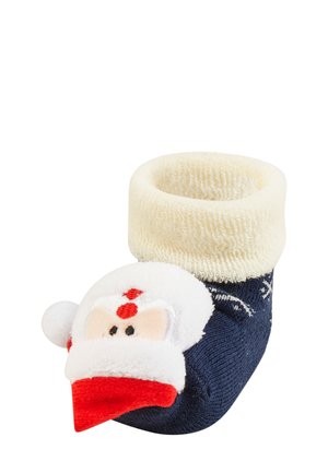 Navy blue sock with a cream cuff, featuring a plush Santa face with red accents, black eyes, and a textured surface.