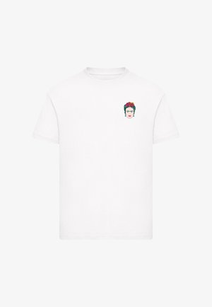 White short-sleeve t-shirt with small colorful Frida Kahlo face design and red flowers on the upper left chest area.