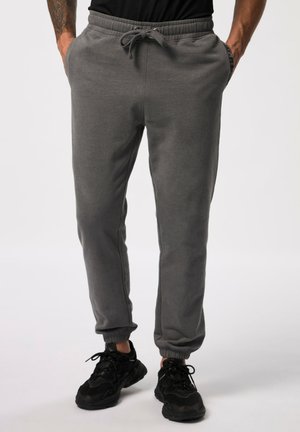 Gray sweatpants with elastic waistband, drawstring, side pockets, and cuffed ankles. Fabric appears soft with a smooth texture.