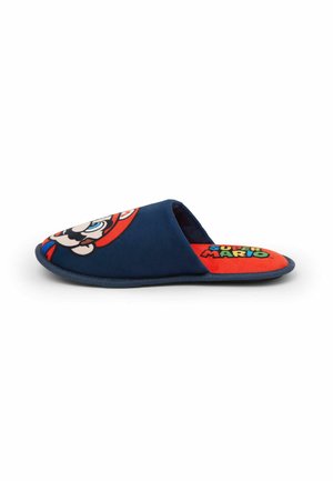 Blue plush slipper featuring a 3D Mario design on the upper, red inner lining, and a flat sole. Smooth texture with cartoon accents.