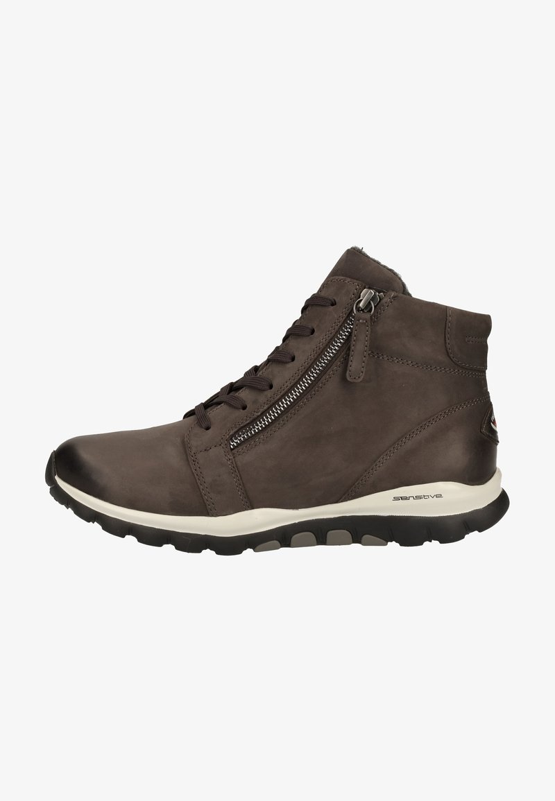 Zapato de cuero marrón de media caña con punta redonda, que cuenta con un zipper lateral, cordones en la parte frontal y suela de goma con detalles texturizados.