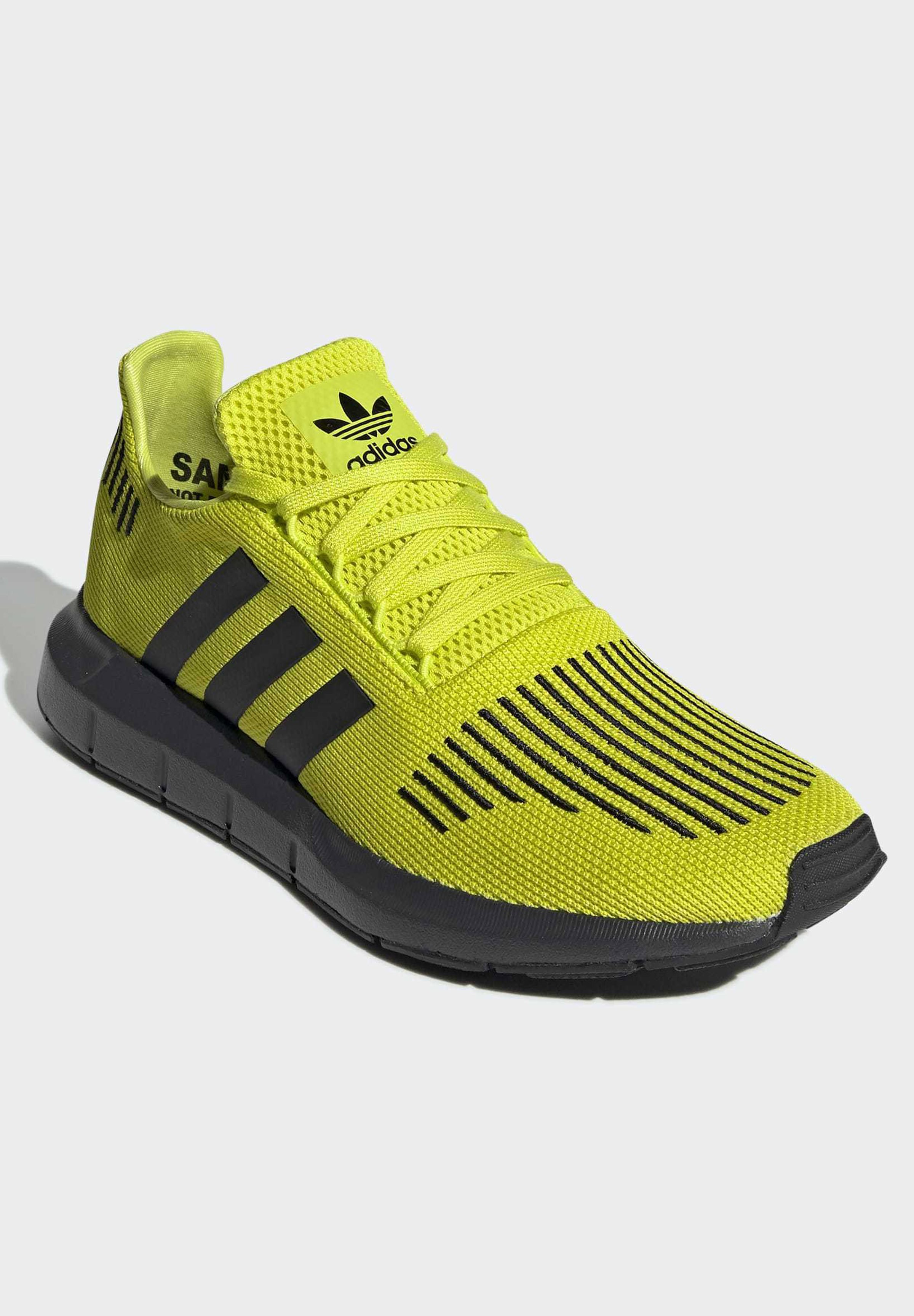 yellow adidas running trainers