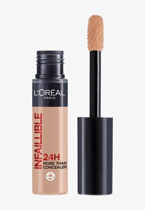 Correcteur L’Oréal Paris Infallible 24H avec capuchon noir ouvert et applicateur beige montrant le correcteur crémeux au bout.