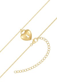 Guldfärgad halsband med ett hjärtfomad lås med nyckelhål, kompletterat av en delikat kedja och justerbar länkdetalj.