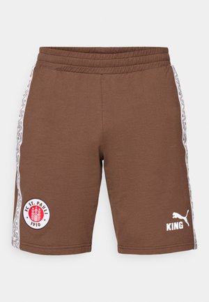 Pantalones cortos deportivos marrones hechos de algodón, con una cintura elástica, rayas laterales con patrones y logotipos: FC St. Pauli y Puma en blanco.