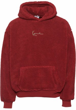 Rød fleece hoodie med en tekstureret overflade, en frontlomme og en hætte med snørebånd. Har et guldbroderet logo på brystet.