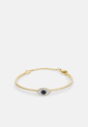 Gouden armband met een centraal oogmotief, versierd met zwarte en heldere stenen langs een verfijnde ketting. Eenvoudig, elegant ontwerp.