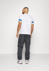 Sergio Tacchini CARSON - Calças de fato de treino - ebony/white