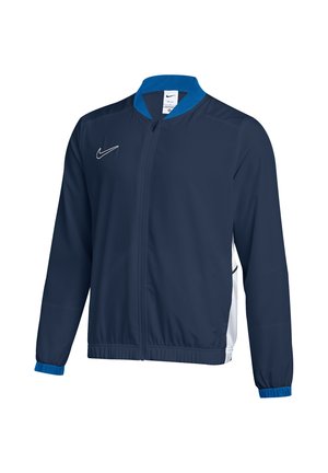 Dunkelblaue Nike Zip-Jacke mit hellblauem Kragen und Bündchen, weißen Seitenpaneelen und Nike-Logo auf der Brust.