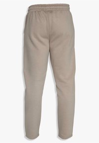 Beige sweatpants with a stretchy waistband, tapered legs, and smooth texture. Features two side pockets.