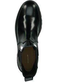 Black leather ankle boot with a glossy finish, elastic side panels, and a round toe. Features a pull tab and sturdy rubber sole.