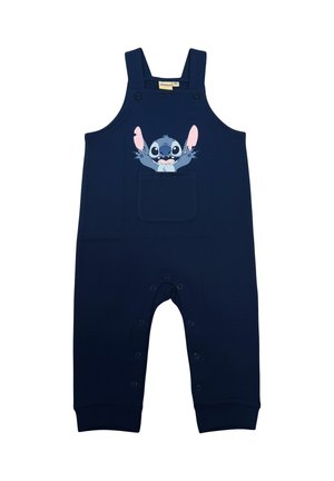 Tutina per neonati blu navy con bretelle, tasca frontale e un personaggio dei cartoni animati con le braccia distese stampato sopra la tasca.