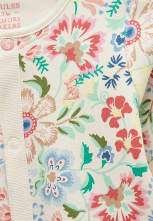 Stoff mit Blumenmuster in Pink, Blau, Rot und Grün, zart besticktem rosa Hasen und cremefarbenem, geknöpftem Rand.