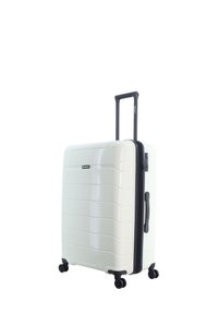 Hard-shell suitcase in glossy white with horizontal grooves, black zipper, and telescoping handle. Features four spinner wheels for mobility.