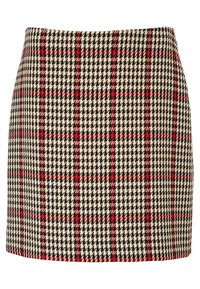 Jupe trapèze taille haute avec un motif pied-de-poule et tartan beige, noir et rouge, comportant des rayures rouges verticales et horizontales.