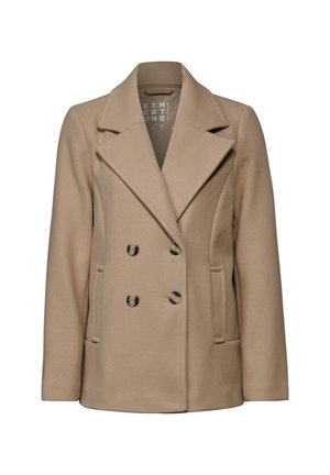 Manteau beige croisé en tissu doux, doté de grands revers, de deux poches avant et de boutons métalliques pour la fermeture.