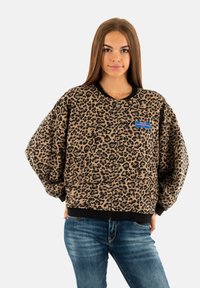 Bomber jacket con stampa leopardata, dotata di chiusura a zip frontale, tasche laterali e polsini e orlo in tessuto a coste neri. Tessuto morbido con una vestibilità rilassata.