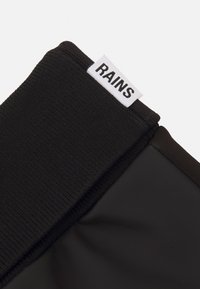 Black waterproof gloves with a textured fabric cuff and smooth, matte finish. Features a white label with "RAINS" logo on the cuff.