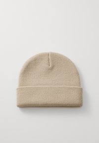 Knit beanie in light beige, featuring a soft texture, a simple rounded top, and a folded cuff for a snug fit.