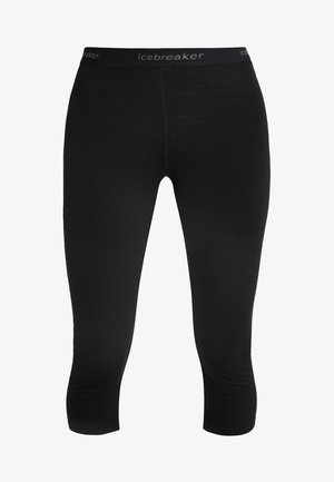 Czarne legginsy do połowy łydki z elastycznego materiału. Posiadają elastyczny pas z nazwą marki "icebreaker" wydrukowaną na szaro.