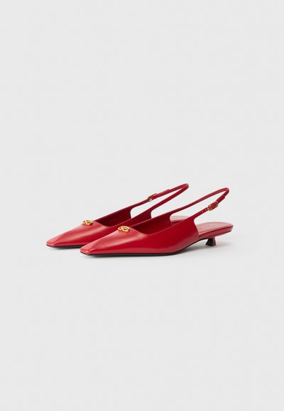 Red leather slingback shoes with a pointed toe, featuring a gold logo accent and a low, block heel. Smooth texture and minimal design.