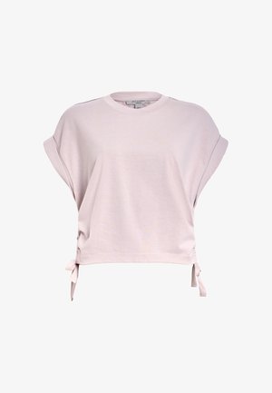 T-shirt rose clair à manches courtes en tissu doux. Doté d'un col rond, de liens sur les côtés et d'une coupe décontractée pour un port confortable.